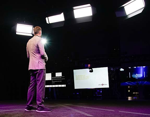 Video Production Studio, view of a presenter in front of screen and lights